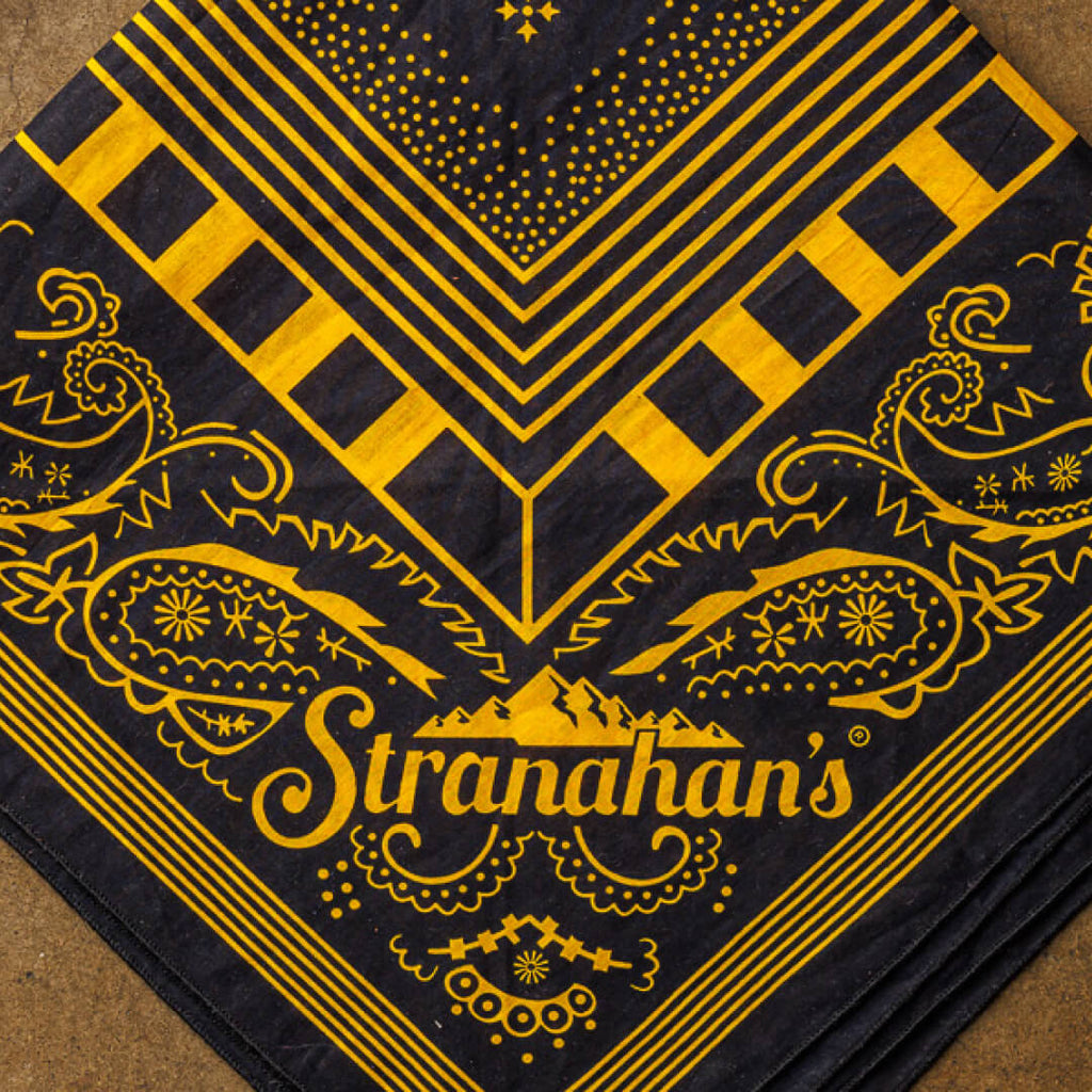 Closeup of yellow and black Bandits Bandana wtih Stranahan's logo pattern