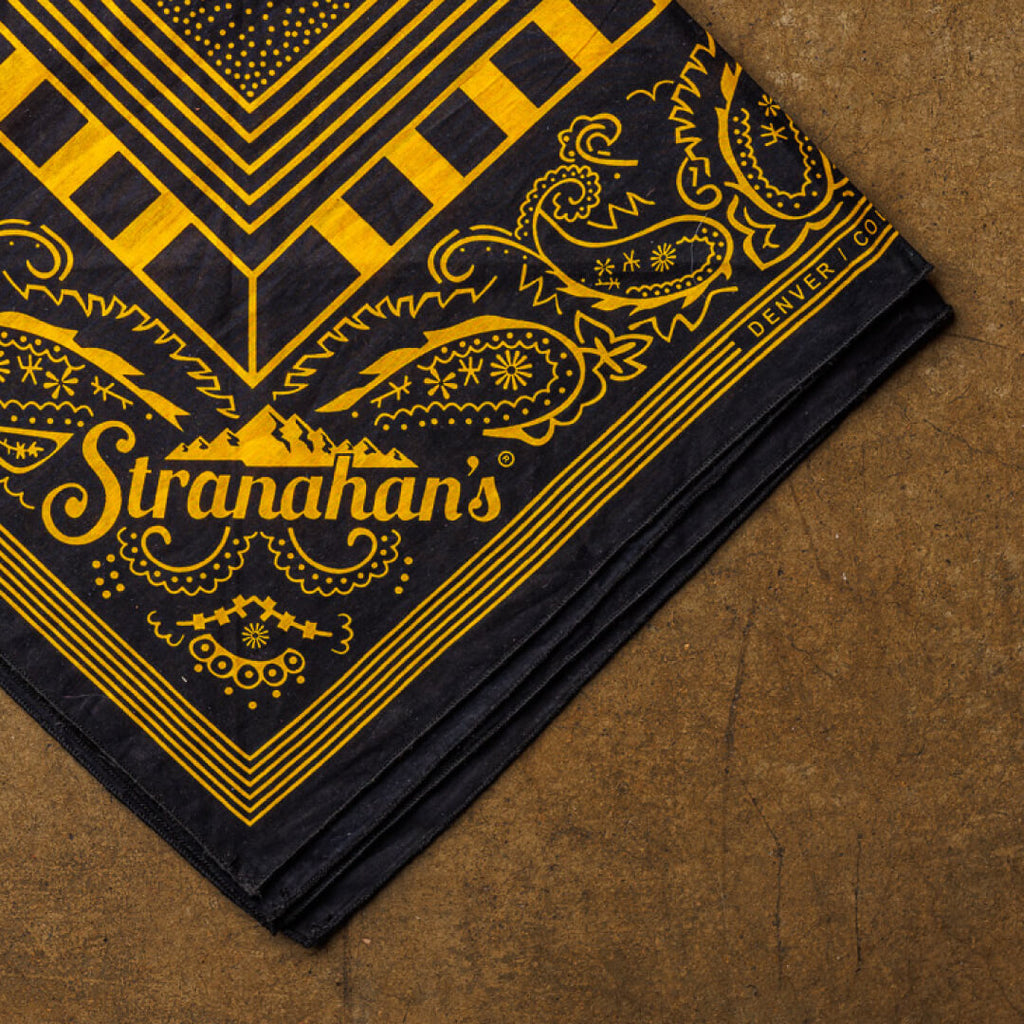 Closeup of yellow and black Bandits Bandana wtih Stranahan's logo pattern