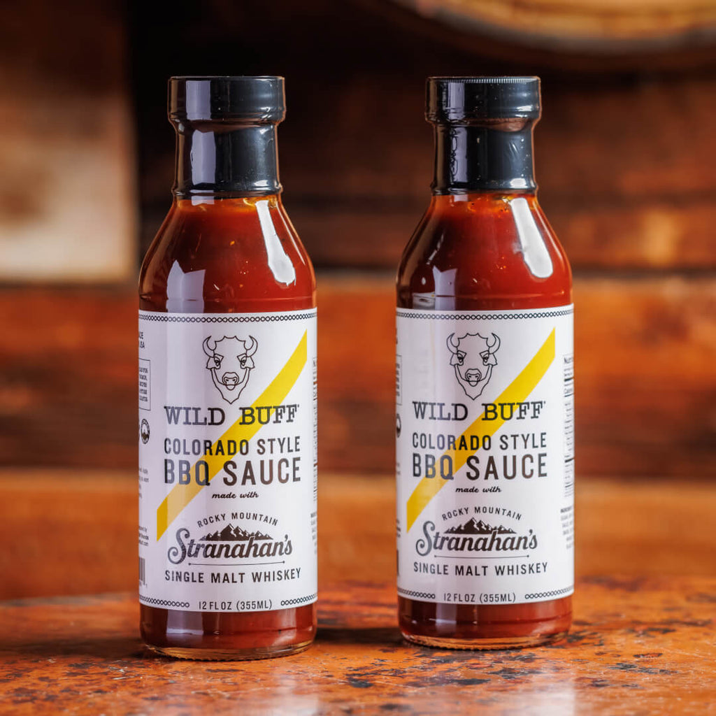 Two bottles of Stranahan's x Wild Buff Whiskey BBQ Sauce.