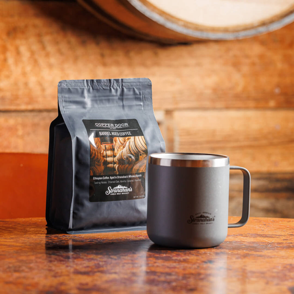 Stranahan's Barrel aged coffee packaging paired with a gray Stranahan's mug
