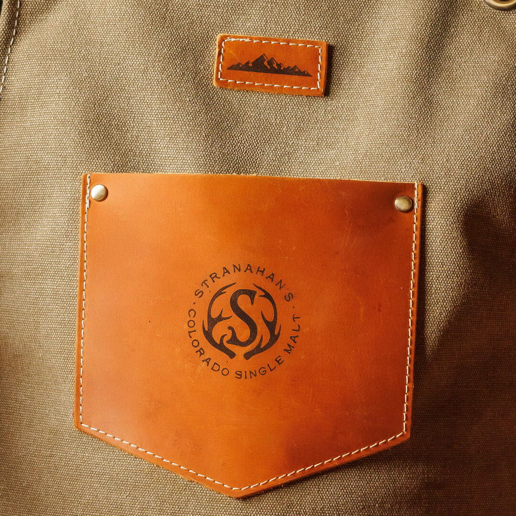 Closeup of logo leather pocket on center of Stranahan's bartender apron.