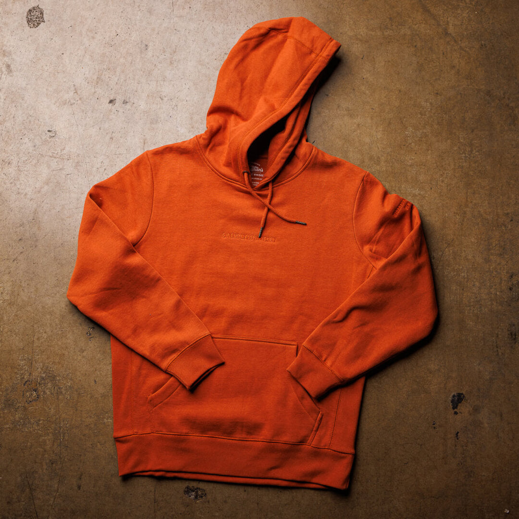 Flatlay overhead view of burnt orange Stranahan's Embroidered Clay Sweatshirt