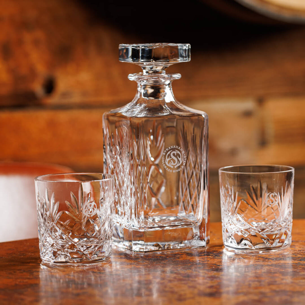 Family shot of Glencairn Glass decanter with two rocks glasses placed on each side of the decanter