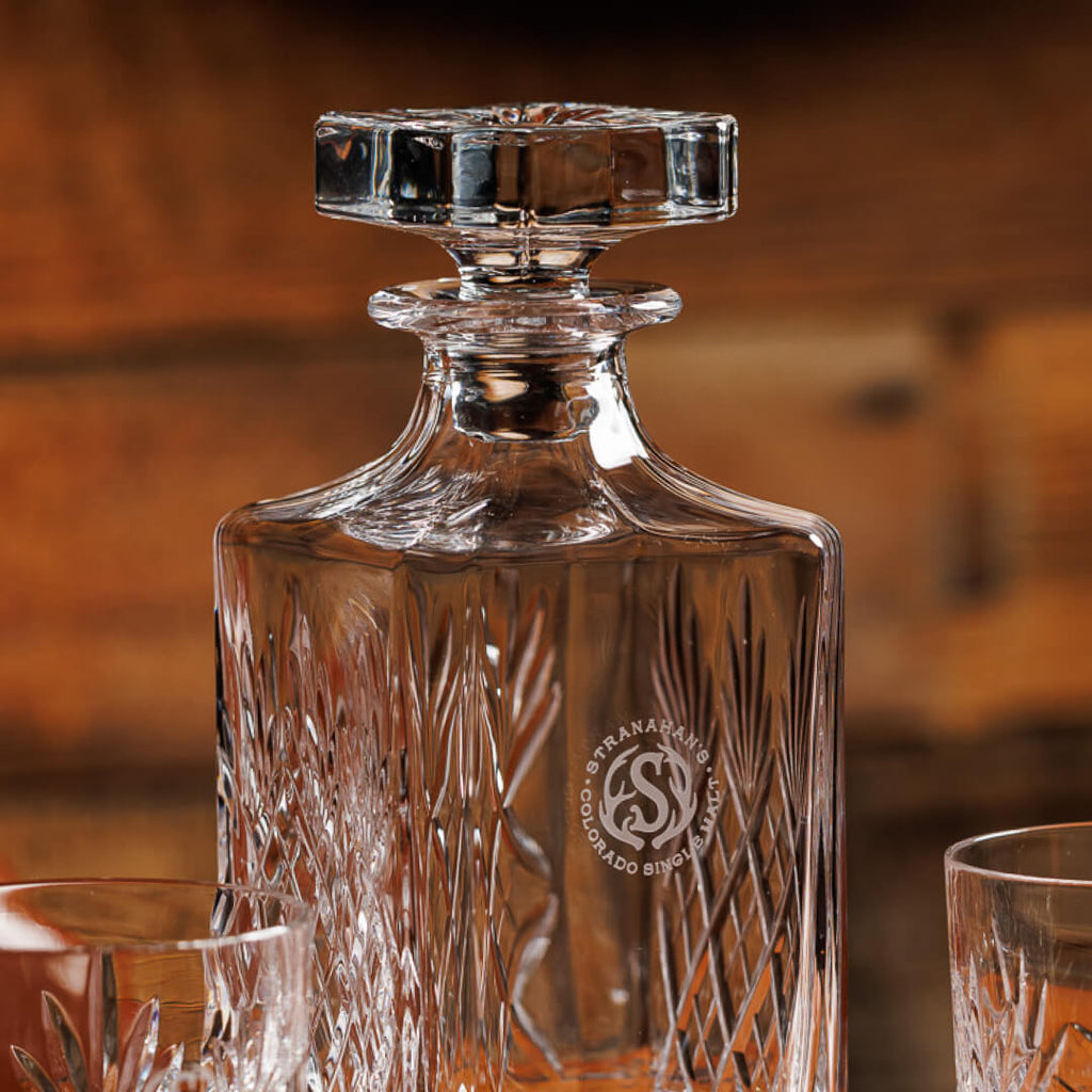 Closeup shot of a glass-etched Stranahan's logo on the decanter