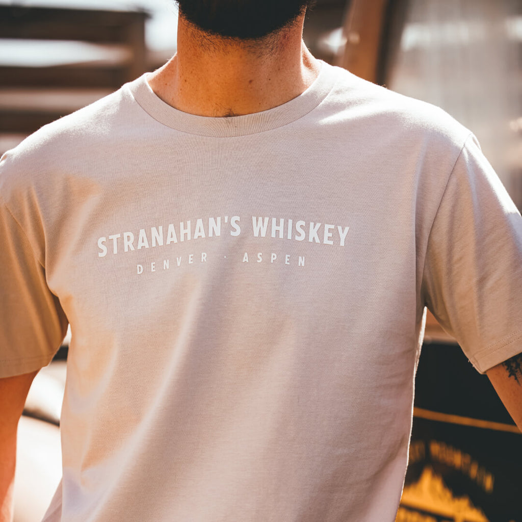 Front view of Stranahan's Rockies On The Rocks tee with Denver and Aspen location callouts