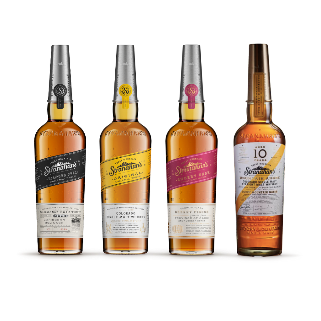 Four bottles of Stranahan's whiskey, including Original, Blue Peak, Sherry Finish, and Mountain Angel 10 Year, displayed in a row.