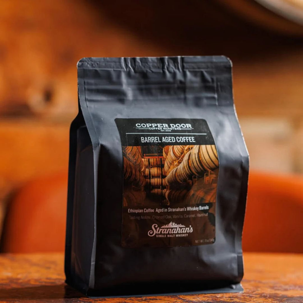 Copper Door Barrel Aged Coffee bag, featuring Ethiopian coffee aged in Stranahan's whiskey barrels.