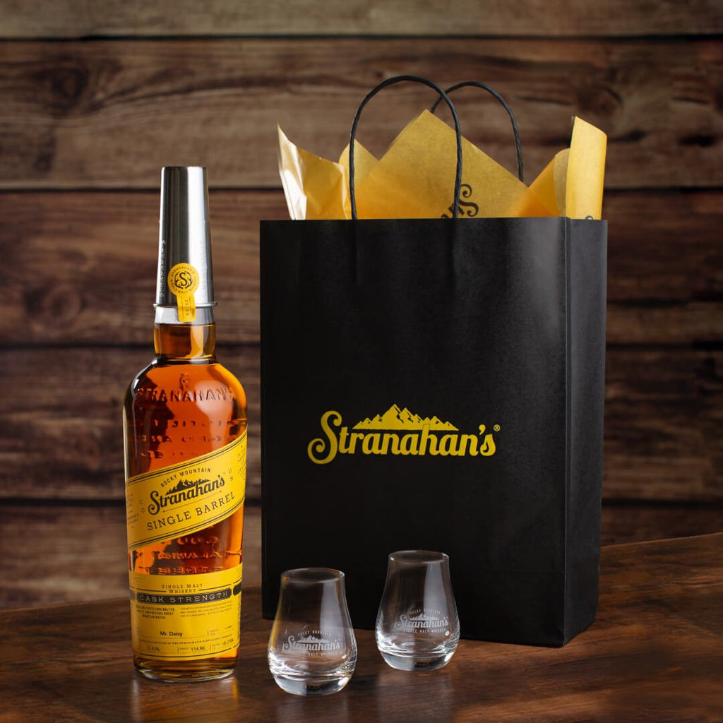 Stranahan's Whiskey Lover's Bundle on rustic surface