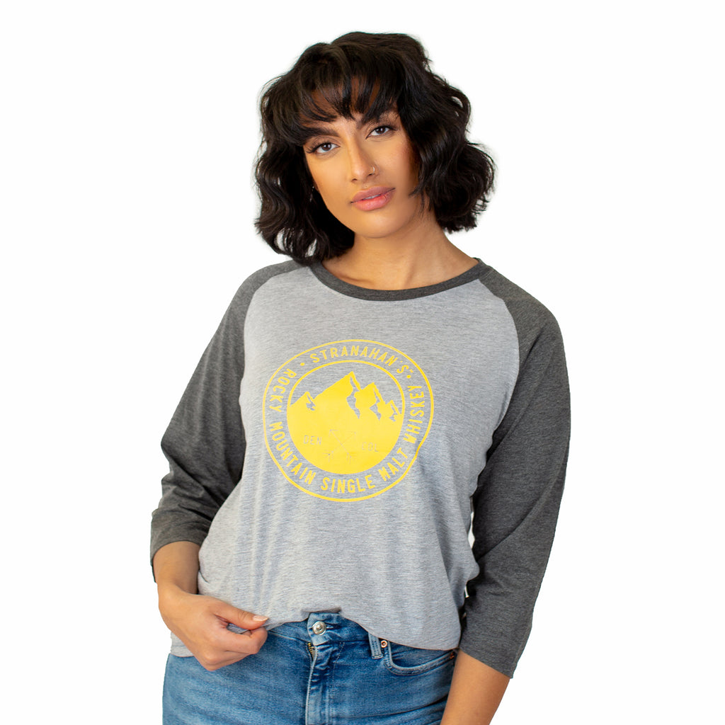 Front view of female model wearing a grey Stranahan's baseball tee.