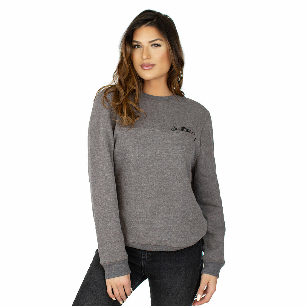 Front view of female model wearing grey crewneck pullover with black Stranahan's logo.