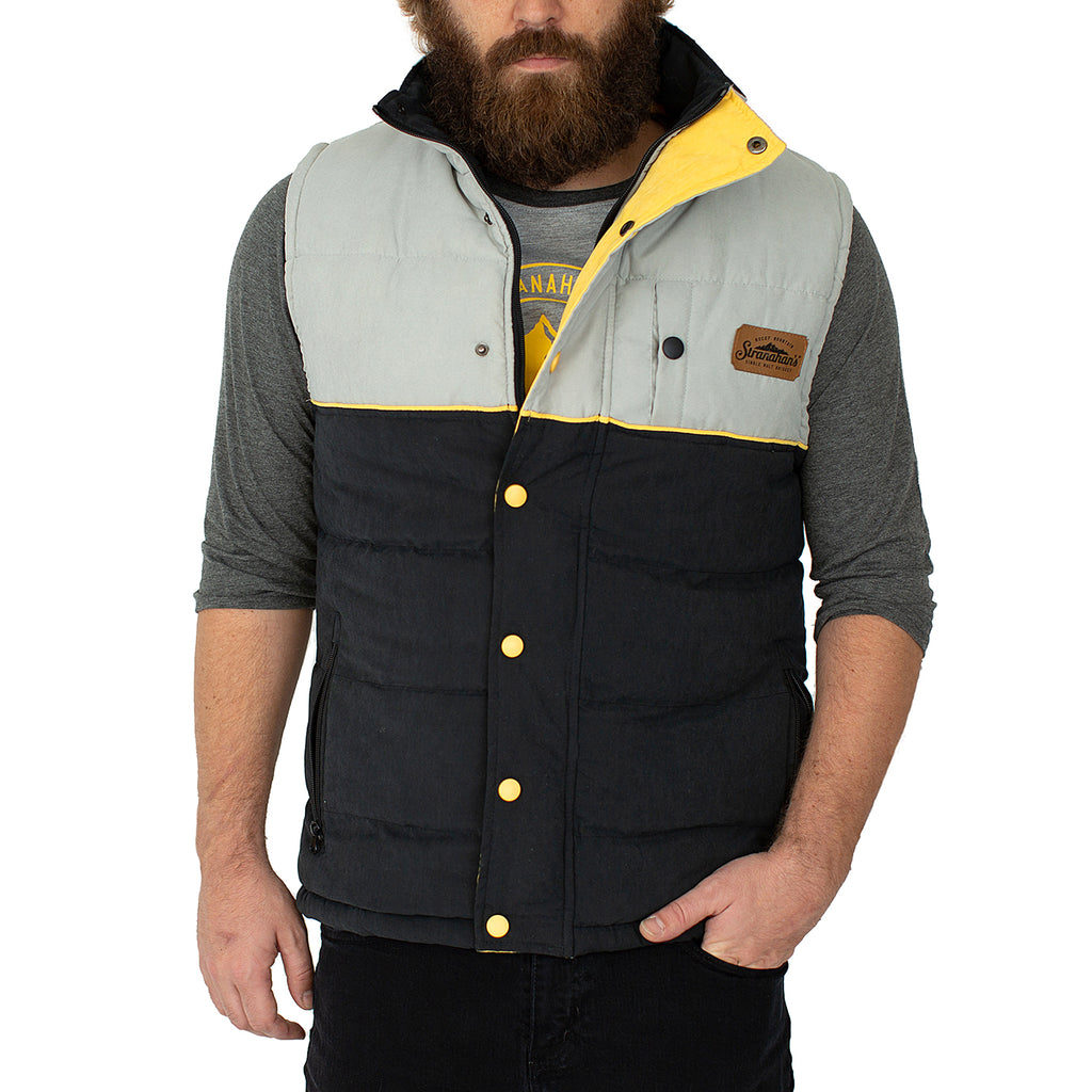Front view of buttoned Stranahan's puffer vest on male model.