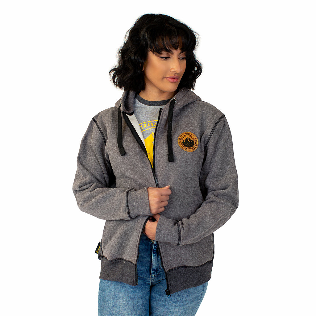 Front view of Stranahan's grey zip hoodie on female model.