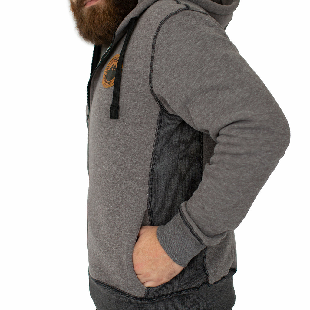 Side view of Stranahan's grey zip hoodie on male model.
