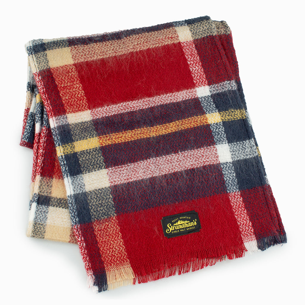Plaid scarf with Stranahan's logo folded in a square.