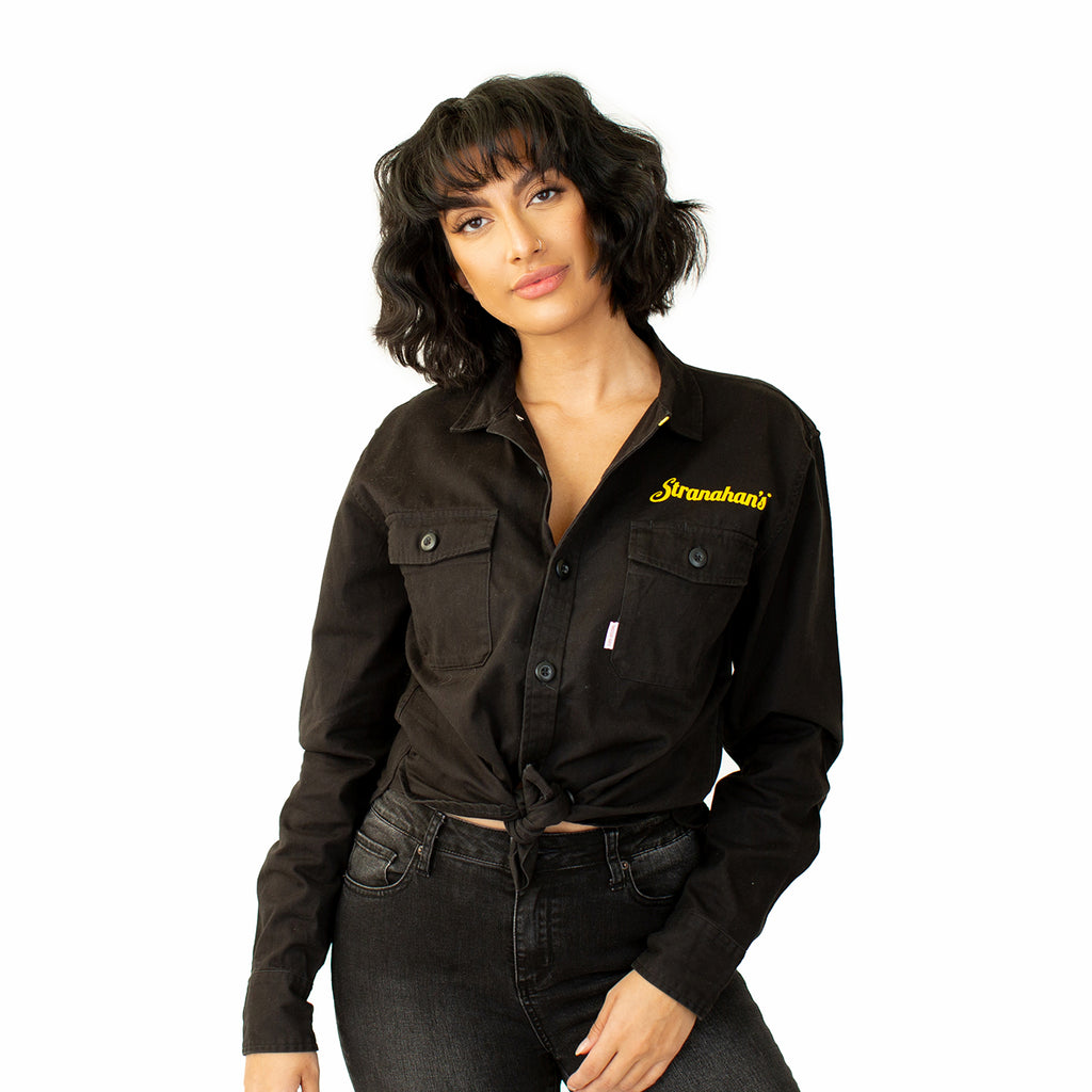 Front view of Stranahan's black work shirt on female model.