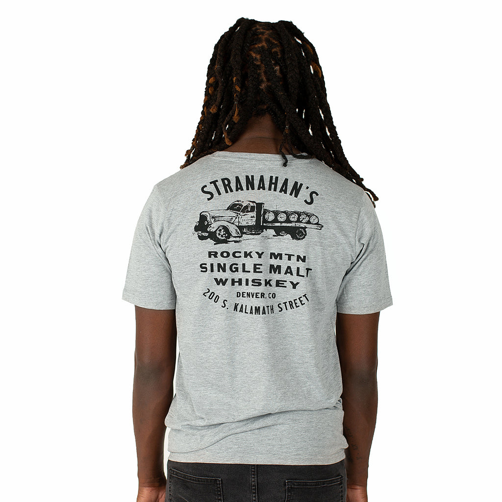Back view of male model wearing a grey Stranahan's barrel truck tee.