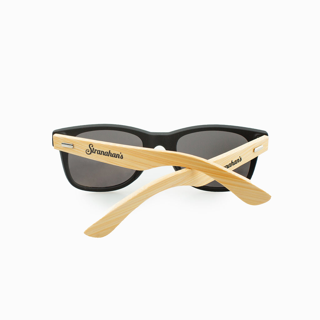 Back view of wood stemmed sunglasses with Stranahan's logo